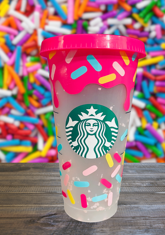 A 16 oz BPA-free Starbucks-compatible reusable cold cup with a sprinkle pattern vinyl wrap. Purple confetti appears when filled with cold liquid. Includes a clear lid and reusable straw, perfect for iced coffee lovers and fun drinkware fans.