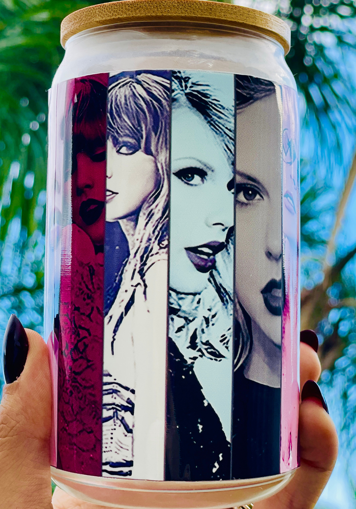 A 16oz BPA-free glass cup with a UVDTF wrap featuring Taylor Swift's iconic eras, complete with a bamboo lid and reusable glass straw. Perfect for Swifties and cold drinks.