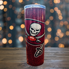 Load image into Gallery viewer, A 20 oz stainless steel insulated tumbler featuring a glittery red design with the Tampa Bay Buccaneers flag logo. Comes with a clear lid, metal straw, and straw cleaner, perfect for hot and cold drinks. Discounted due to a thin white seam on the back.
