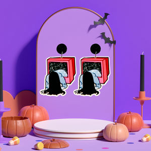 Purple jewelry holder with earrings featuring a cartoon-style figure climbing out of a TV, inspired by The Ring, perfect for fans of horror movies and unique Halloween accessories.