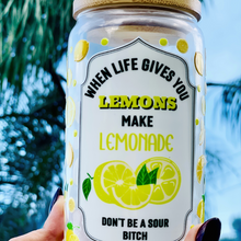 Load image into Gallery viewer, 16 oz BPA-free glass cup with a vibrant lemon design and cheeky quote: &#39;When life gives you lemons, make lemonade, don’t be a sour bitch.&#39; Includes a bamboo lid and reusable glass straw.
