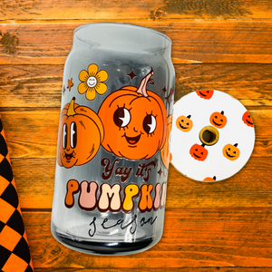 A 16 oz BPA-free glass cup featuring a cute pumpkin design with the words “Yay it’s Pumpkin Season.” Comes with a bamboo lid and reusable glass straw, perfect for autumn drinks.