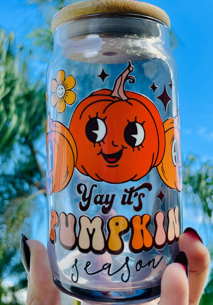 A 16 oz BPA-free glass cup featuring a cute pumpkin design with the words “Yay it’s Pumpkin Season.” Comes with a bamboo lid and reusable glass straw, perfect for autumn drinks.