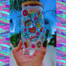 Load and play video in Gallery viewer, A 16oz BPA-free glass cup featuring a colorful 90s-themed UVDTF wrap with icons like Game Boys, cassette tapes, roller skates, and boomboxes. Comes with a bamboo lid and reusable glass straw, perfect for nostalgic drinkware lovers.
