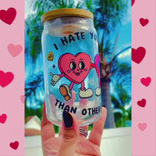 Load and play video in Gallery viewer, A 16 oz glass cup featuring a UVDTF wrap with two hand-holding hearts and the phrase “I Hate You Less Than Other People.” Comes with a bamboo lid and reusable glass straw, perfect for cold drinks. BPA-free and handwash only.
